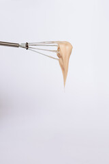 stylist kneads hair dye in a black container close up