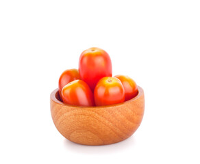 red tomatoes in wooden bowl on white background