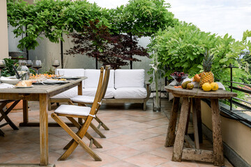dining table with wooden chairs set on the terrace with beautiful italian landscape. food concept