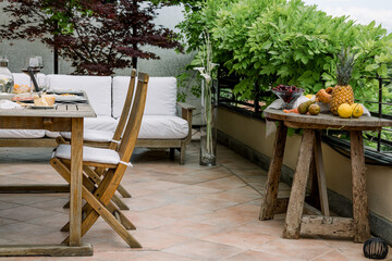 dining table with wooden chairs set on the terrace with beautiful italian landscape. food concept