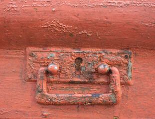 A handle on an old chest of drawers. Old, cracked, subject to restoration.