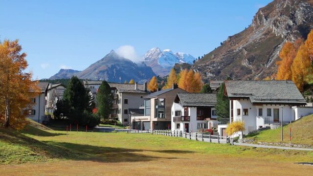Colorful autumn scene of Maloja village from Sils lake. Panoramic morning view of Swiss Alps. Bright  autumn scene of Switzerland, Europe. Full HD video (High Definition).
