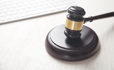 Judge gavel with computer keyboard. Concept of internet crime
