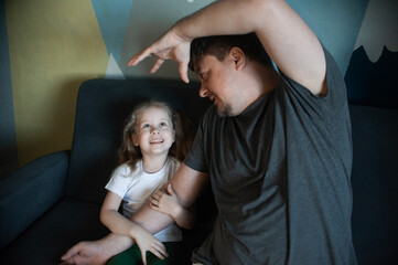 Obraz premium dad plays at home with his children: daughters, son