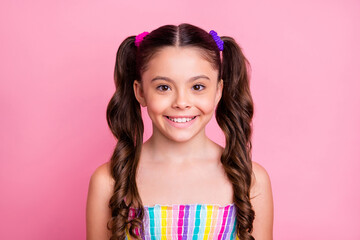 Closeup photo of beautiful little lady model with two lovely cute tails good mood wear casual colored rainbow dress summer singlet isolated pastel pink color background