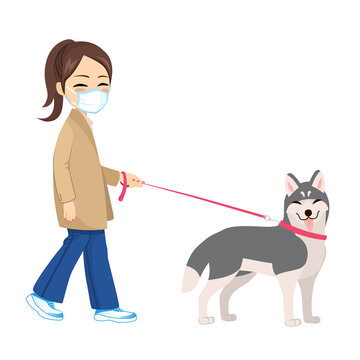 Young woman walking dog with medical mask coronavirus pandemic concept