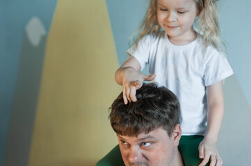 dad plays at home with his children: daughters, son