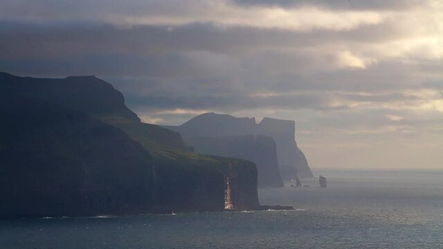 Time lapse clip. Summer view of Risin og Kellingin cliffs. Evening scene of Eysturoy island, Atlantic ocean, Faroe Islands, Denmark, Europe. Full HD video (High Definition).
