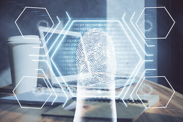Computer on desktop in office with finger print drawing. Double exposure. Concept of business data security.