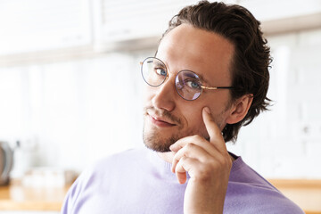 Close up of a smiling yong handsome man wearing glasses
