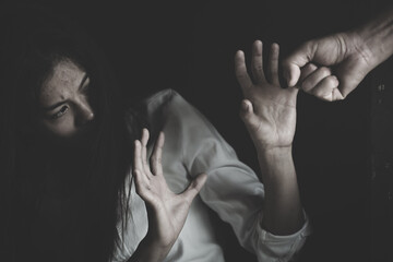 Woman victim of domestic violence and abuse. Husband intimidates his wife. Man beating up his wife...