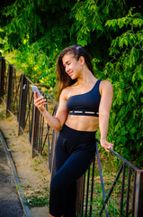 Smiling woman with phone in park