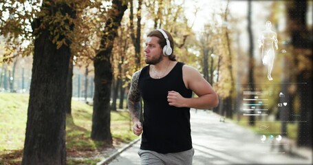 Augmented Reality Interface with Health Data Futuristic fitness tracker app. Man running athlete runner training tough cardio exercise workout in park wearing earphones. Healthy lifestyle concept.