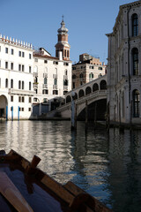 Venice, Italy. View of Rialto's Bridge with no tourists from a traditional venetian boat during coronavirus outbreak.