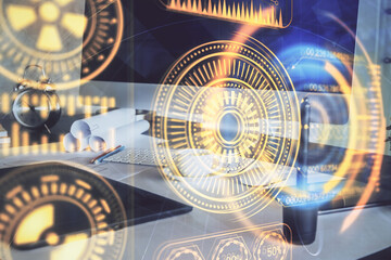 Computer on desktop in office with technology theme hologram. Multi exposure. Tech concept.