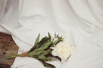 bouquet of white flowers. white peonies lie on a vintage light background