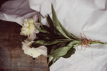 bouquet of white flowers. white peonies lie on a vintage light background