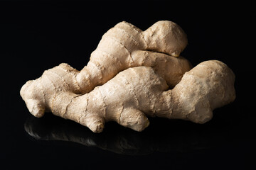Ginger root spice isolated on black background, with reflection
