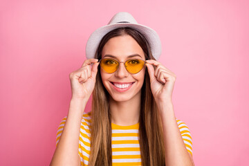 Close-up portrait of her she nice-looking attractive lovely pretty winsome content cheerful cheery girl touching specs isolated over pink pastel color background