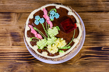 Kiev cake with cream, nuts and meringue on a wooden table. Top view