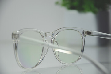 Back view of transparent glasses with transparent rim on white table