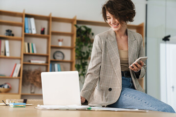 Attractive young businesswoman wearing jacket
