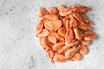 Prawns on a light gray table. Lots of shrimp on the table. Shrimp close-up. The view from the top	