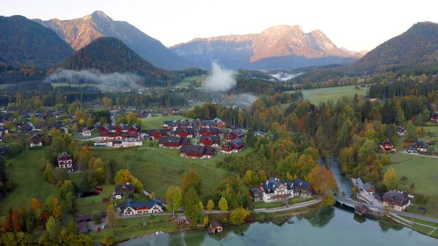 4k drone forward video (Ultra High Definition). Morning scene of Grundlsee lake. Breathtaking autumn view of Roslern village, Liezen District of Styria, Austria, Europe. 