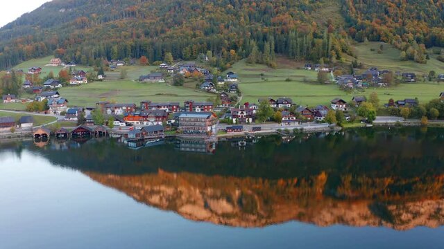 4k drone flight moving to the side footage (Ultra High Definition). Amazing autumn scene of Grundlsee lake. Wonderful morning view of Roslern village, Liezen District of Styria, Austria, Europe. 
