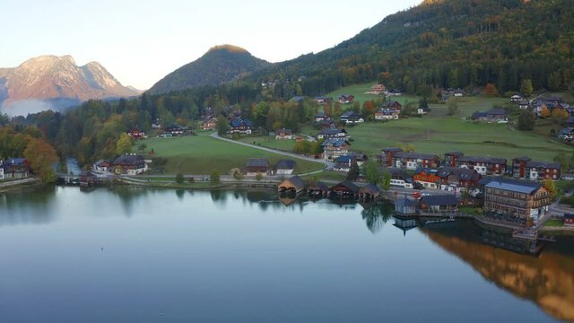 4k drone forward video (Ultra High Definition). Attractive autumn scene of Grundlsee lake. Spectacular morning view of Roslern village, Liezen District of Styria, Austria, Europe. 