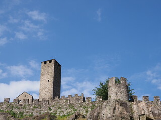 Fototapeta na wymiar Towers of castel grande in european Bellinzona city, capital of canton Ticino in Switzerland, clear blue sky in 2017 warm sunny summer day on July.