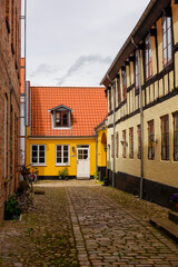 Fototapeta na wymiar Ebeltoft, Denmark A back cobblestoned alley.