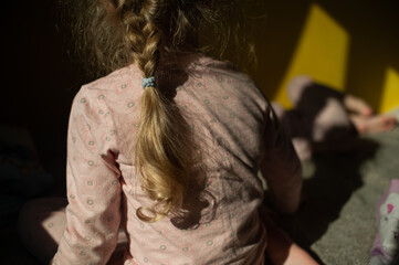  little girl pigtail in the sun at home