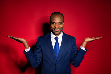 Photo of handsome attractive dark skin business guy holding two open arms demonstrating novelty...