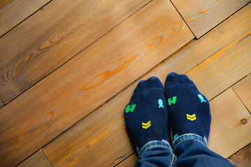 blue socks with geometric patterns on a wooden floor
