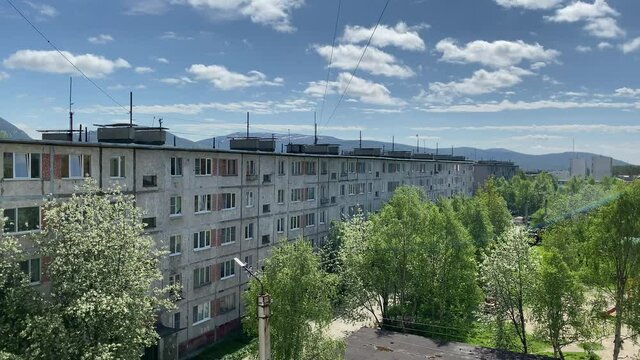 Very beautiful view of the windows from the courtyard and mountains and sky. The inscription on the transformer substation TP-86 and RU-10 / 0.4 kV. 4K shooting