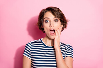 Closeup photo of funky crazy lady short hairdo funny facial expression open mouth arm on cheek listen cool good news wear casual white blue t-shirt isolated pastel pink color background