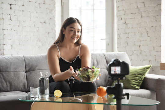 Caucasian blogger, woman make vlog how to diet and lost weight, be body positive, healthy eating. Using camera recording her organic and tasty recipes. Lifestyle influencer, wellness concept.