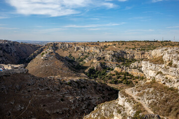 View of Gravina river canyon and park of the Rupestrian Churches of Matera with houses in caves di Murgia Timone near ancient town Matera (Sassi), , Basilicata,  Italy