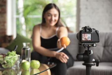 Caucasian blogger, woman make vlog how to diet and lost weight, be body positive, healthy eating. Using camera recording her organic and tasty recipes. Lifestyle influencer, wellness concept.