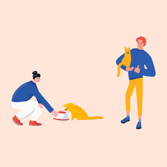 Couple feeding cats and holding in hands in animal shelter