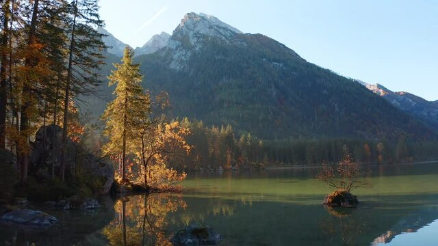 4k drone forward video (Ultra High Definition). Stunning autumn view of Hintersee lake with Hochkalter peak on background, Germany, Europe. Gorgeous morning view of Bavarian Alps. 