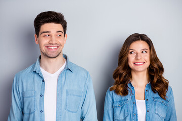 Fototapeta na wymiar Photo two amazing beautiful people lady handsome guy stand side by side look eyes tricky funky childish mood wear casual denim shirts outfit clothes isolated grey color background