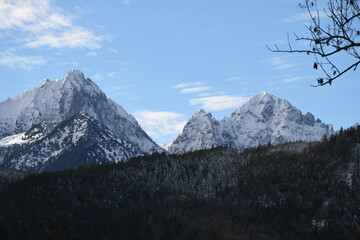 mountains in the alps cowered with snow with blue pure sky in the background.