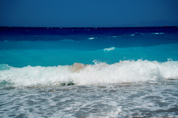 Peaceful sea wave foams on the beach, Aegean Sea, Rhodes, Greece.