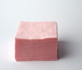 stack of paper disposable pink folded square napkins