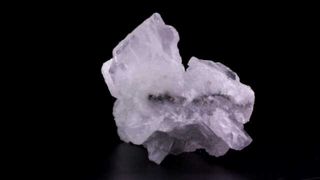 Apophyllite crystals slowly rotating over a black background