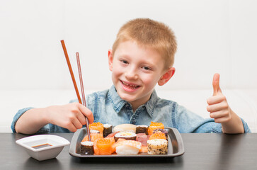 an happy young boy ready for eating sushi