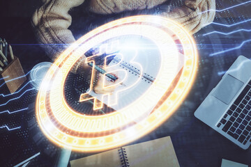 Cryptocurrency hologram over hands taking notes background. Concept of blockchain. Multi exposure