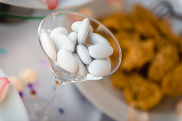 Fototapeta na wymiar Wedding sugar-coated almonds in the vermuth glass. Traditional Italian or Greek treatment.